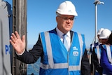 Scott Morrison gestures in a hard hat and high-vis.