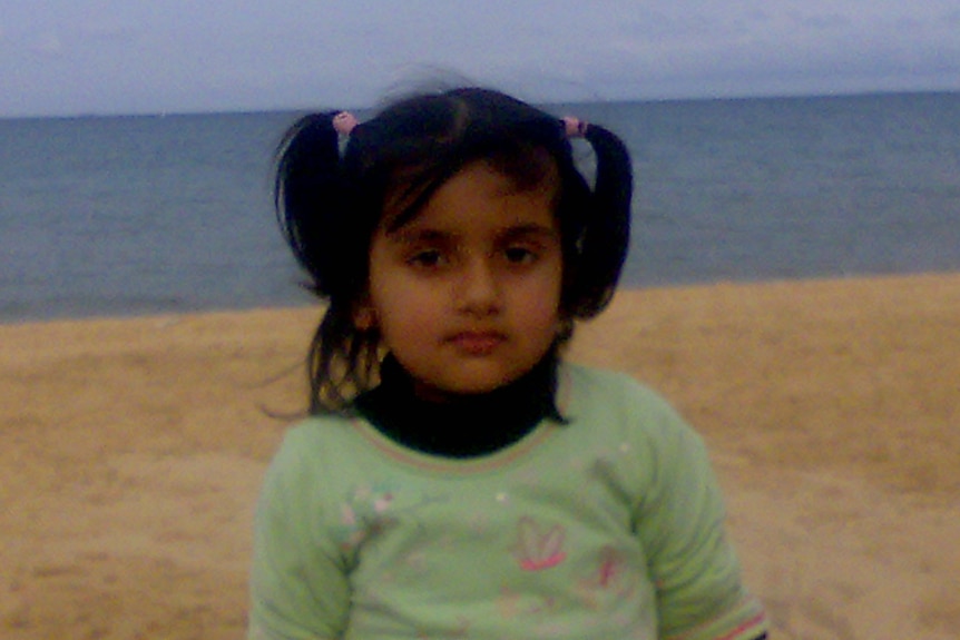 A small child on the beach.