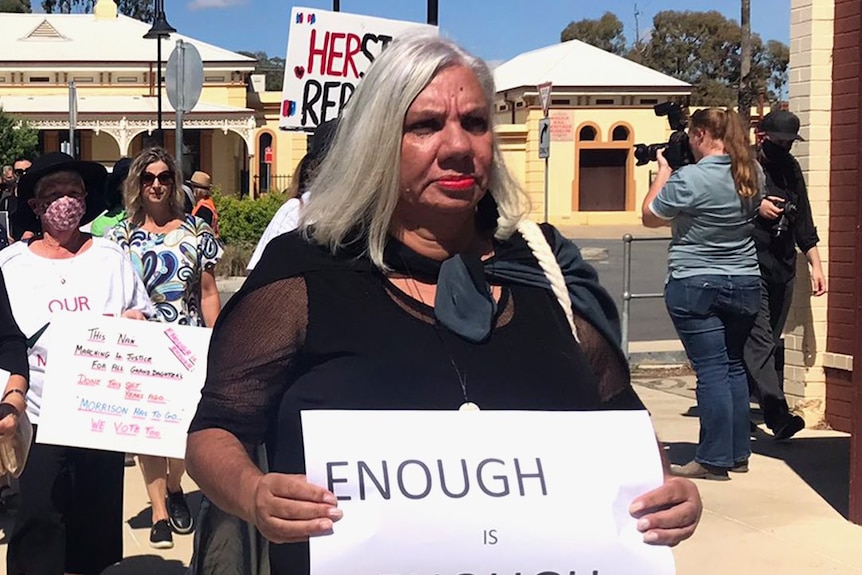 A woman with grey hair and red lips