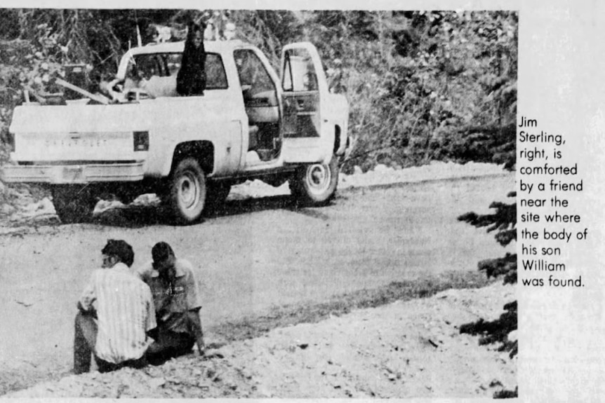 A black and white newspaper scan of two men huddled together in the gutter next to a ute with a dog in the back