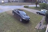 A still from just moments before the car and unidentified driver hit the girl in her front yard.