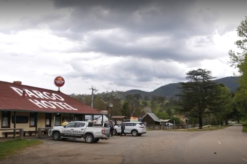 A view of a country road with a pub on the left.