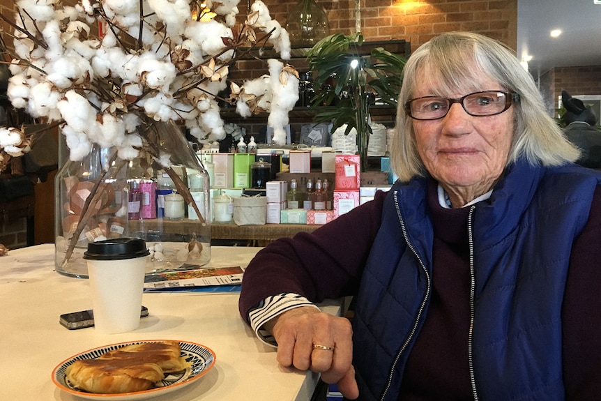 Local resident Janelle Sullivan sitting in the cafe, next to a bunch of cotton.