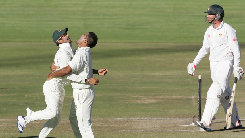 Bangladesh players Nasir Hossain and Ziaur Rahman celebrate the wicket of Zimbabwe's Brendan Taylor.