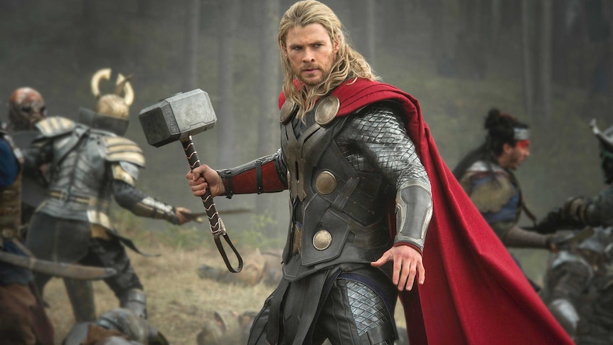 Chris Hemsworth as Thor, holding his hammer during a battle scene in Thor: The Dark World