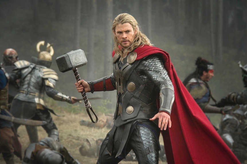 Chris Hemsworth as Thor, holding his hammer during a battle scene in Thor: The Dark World