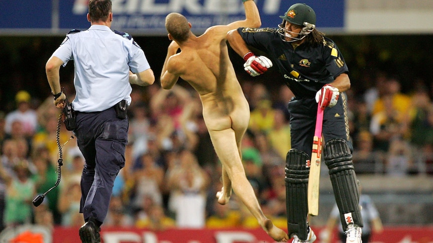 Andrew Symonds knocks a streaker to the ground