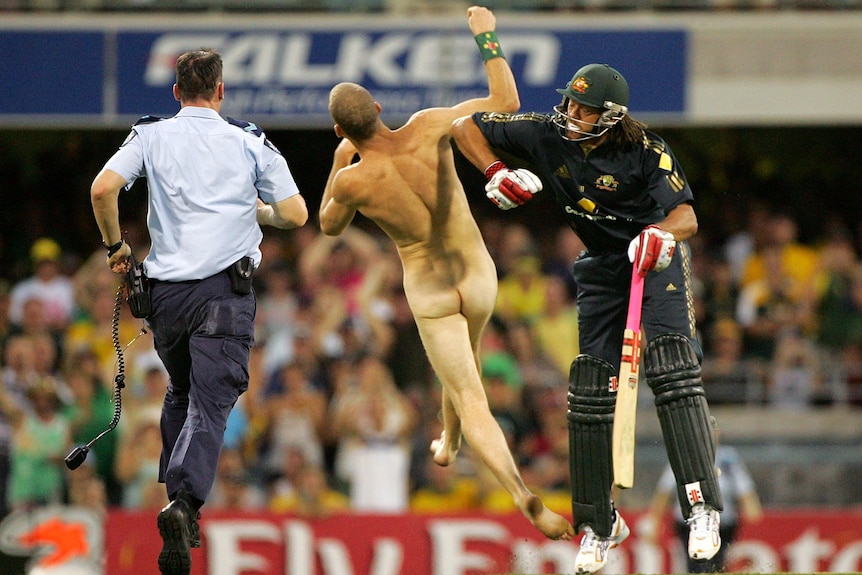 Andrew Symonds knocks a streaker to the ground