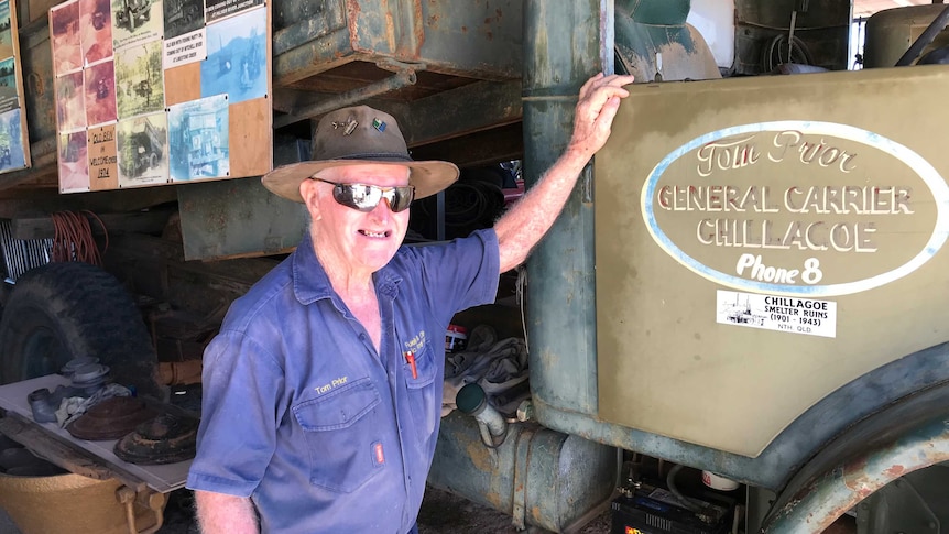 Man leaning against old Ford truck