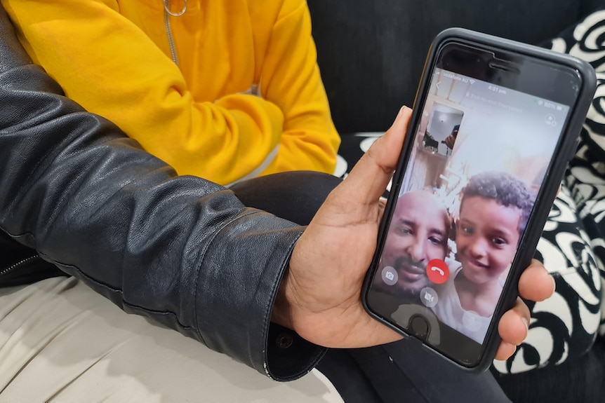 a man and a child's face on a phone screen