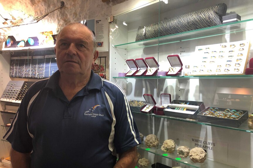 White Cliffs man Dick Wagner standing in his brightly-lit jewellery showroom inside his dugout.