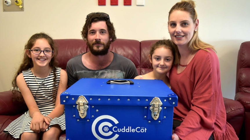 Belle, Leighton, Ava and Anna Heath with the donated cuddle cot.