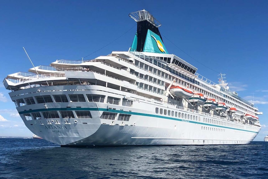 A cruise ship on the water, photographed from below.