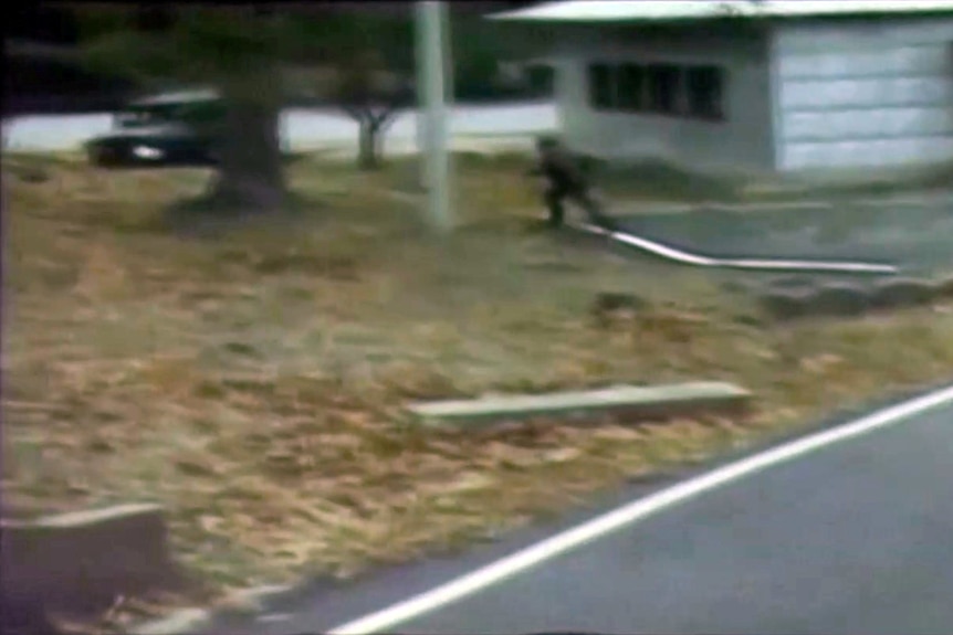 A blurry shot of a soldier running towards a car