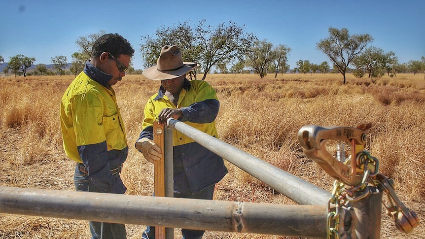 Wayne Nelgun watches on as Lindsay Malay uses a spirit level.