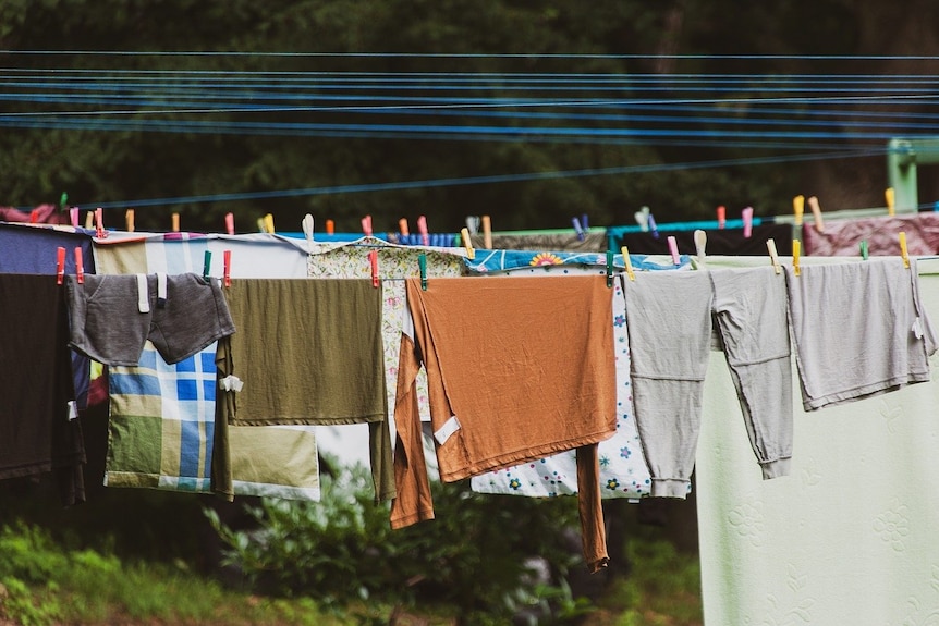 Lots of colourful clothes hanging on a clothesline