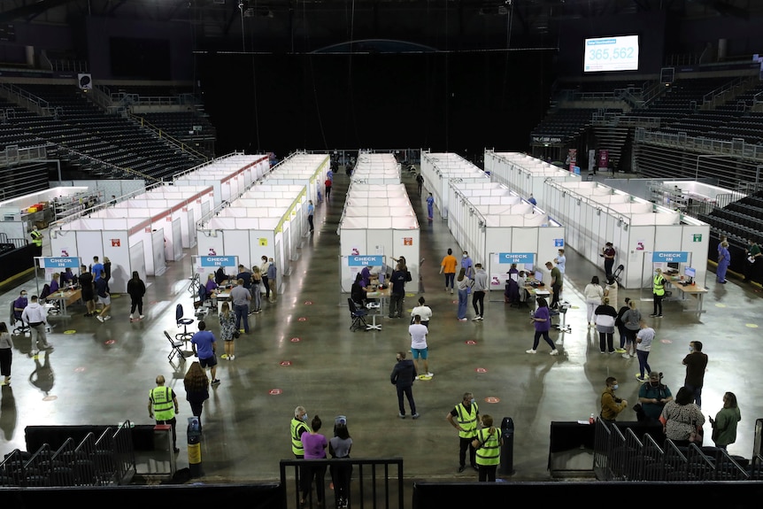 The arena's vaccine clinic is lined with the general public