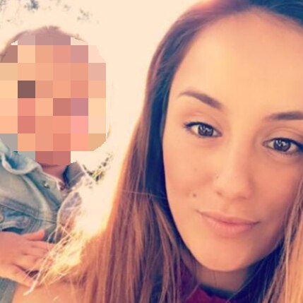A selfie-style shot of a young woman with dark eyes and a child, whose face is blurred out.