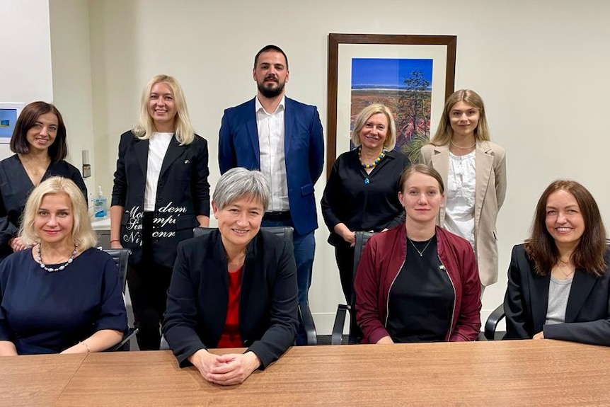 group of ukrainian doctors at desk meet with penny wong