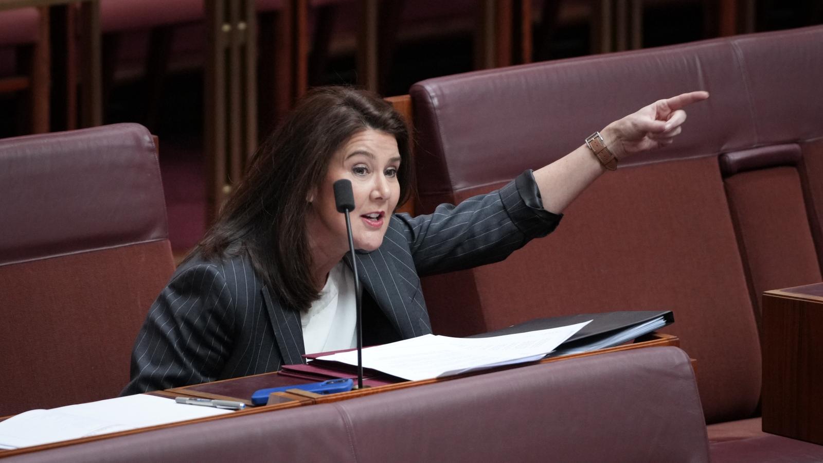 Jane Hume raises her arm in the senate.