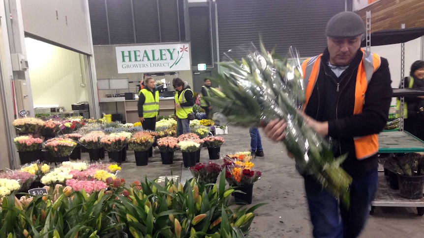 Man with flowers inside Melbourne Market