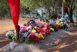 Flowers line a burial site at Elcho Island homeland.