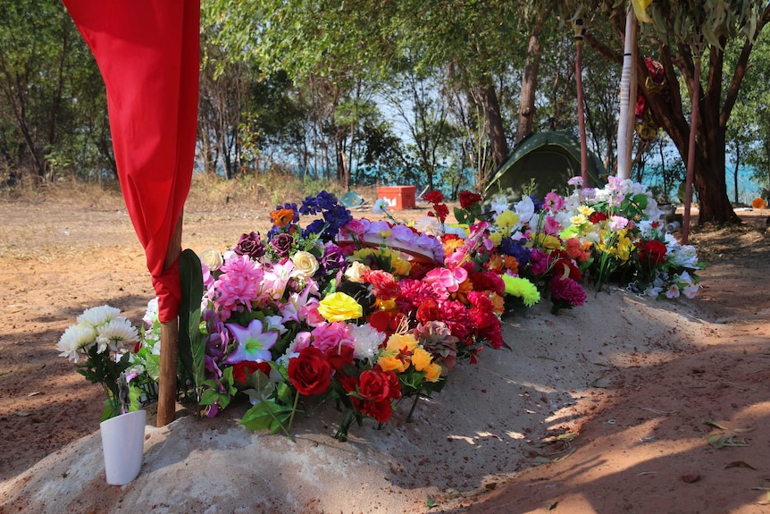 Flowers line a burial site at Elcho Island homeland.