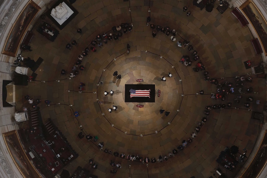 An aerial view shows George HW Bush's coffin lying in the middle of the Capitol Rotunda.