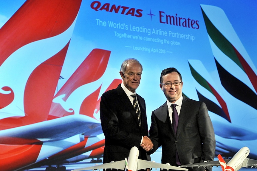 Qantas and Emirates CEOs shaking hands after first inking deal in 2012