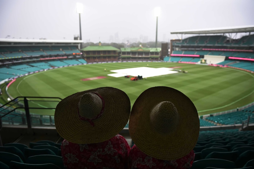 Fans at the SCG as the rain falls