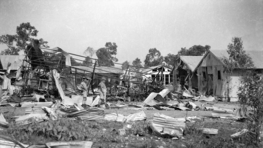 Australian soldiers inspecting damage to defence buildings following a Japanese bombing raid.