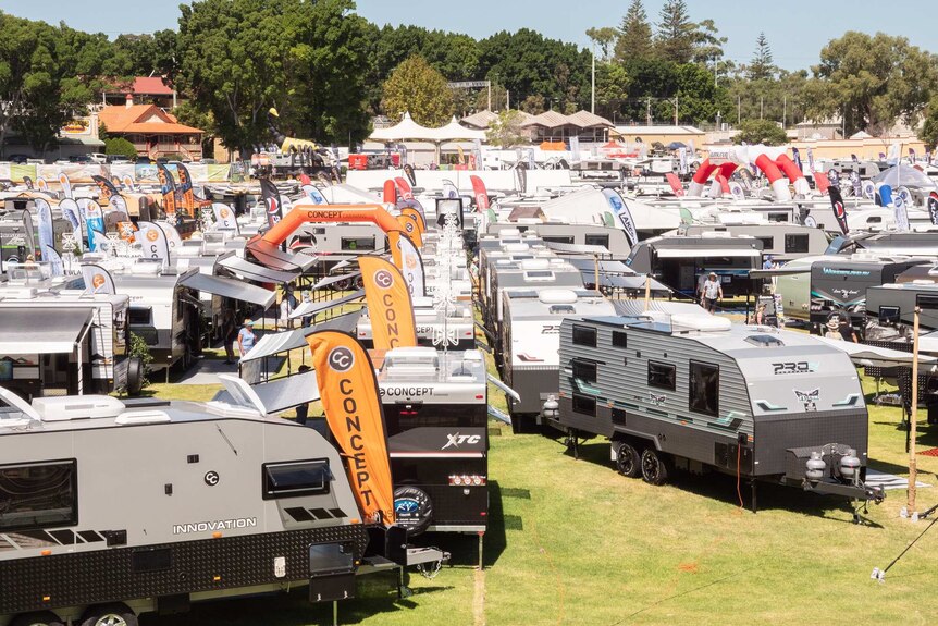 Caravans on display in a grassy field at a caravan and camping show