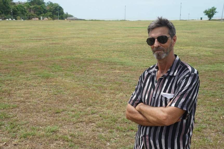 Darwin Council alderman Andrew Arthur stands with his arms crossed at the Little Mindil site.