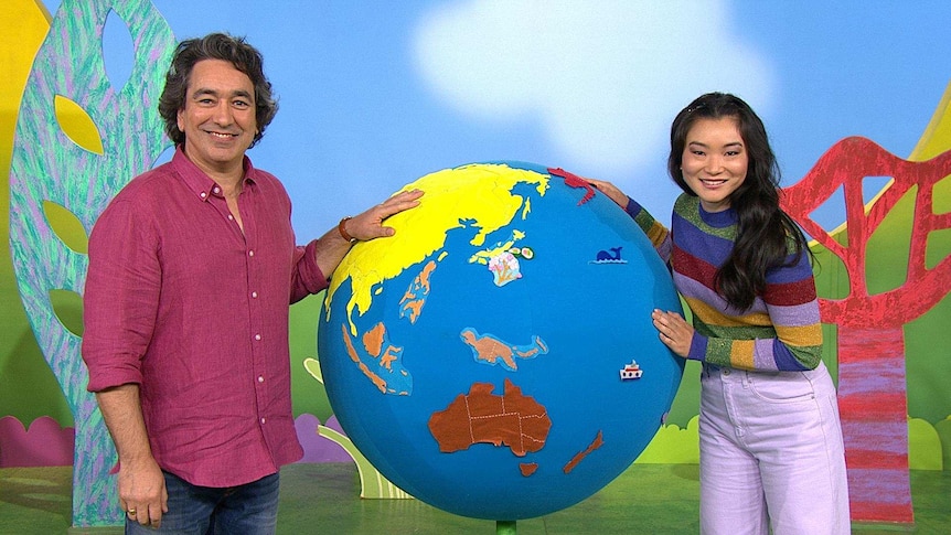 Alex and Michelle with a large globe