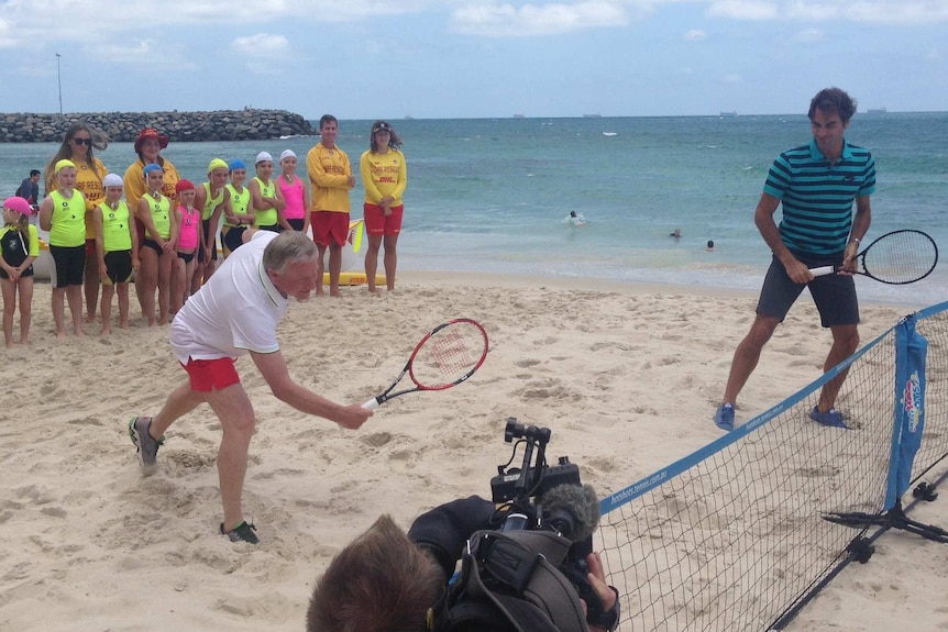Colin Barnett and Roger Federer play tennis on the beach