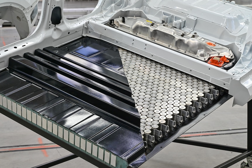 A Tesla EV cut open to show the battery pack
