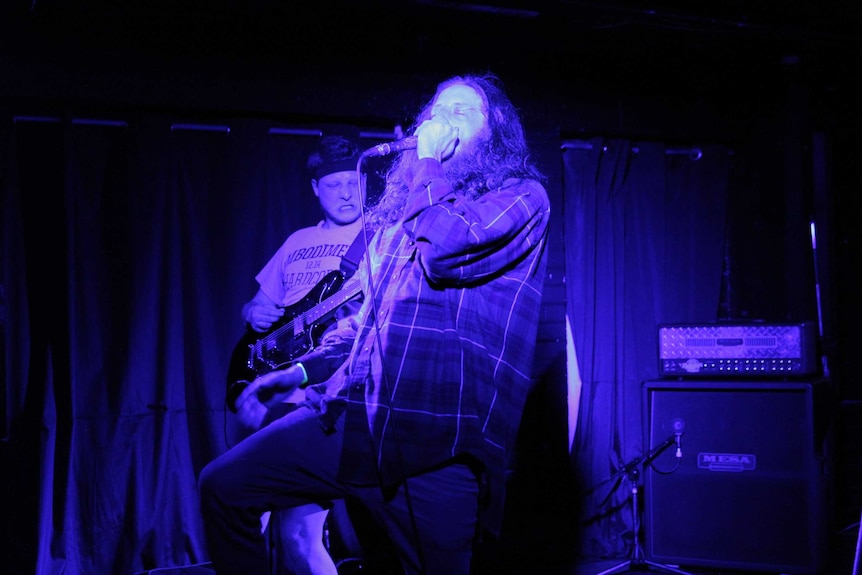 Heavy metal band performing onstage in Brisbane.