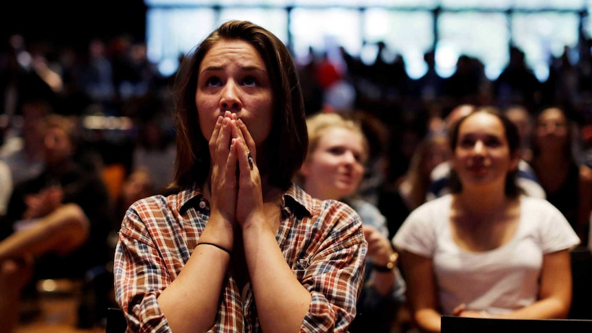 A Hillary Clinton supporter appears anxious as she watches the results.