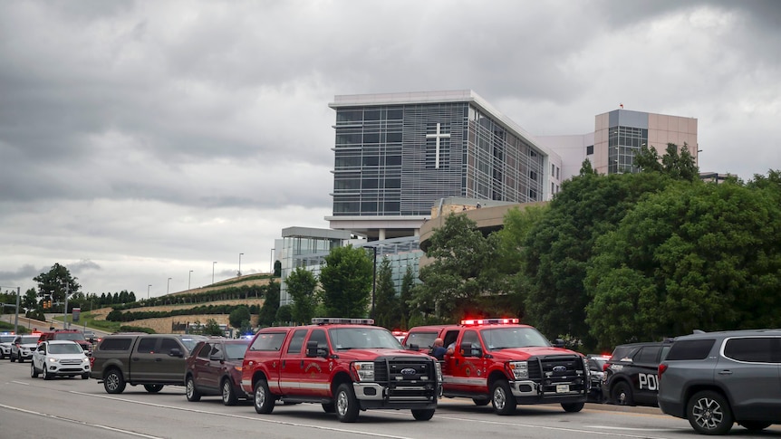 The exterior of the Natalie Medical Building  with first responder vehicles parked outside. 