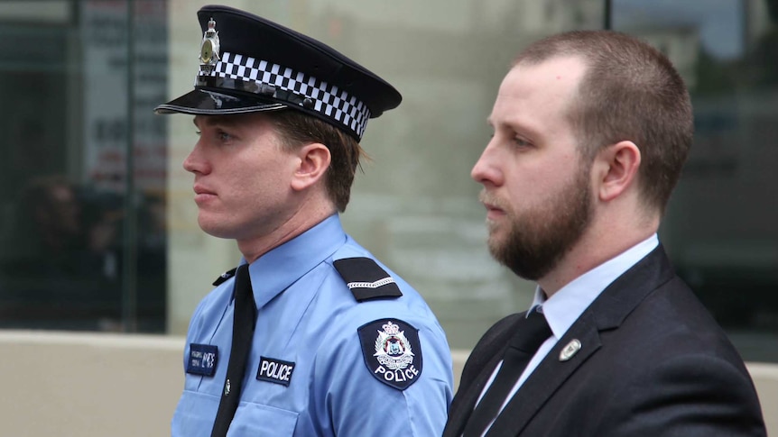 First Class constable Tom Gryta outside court with another, unknown man