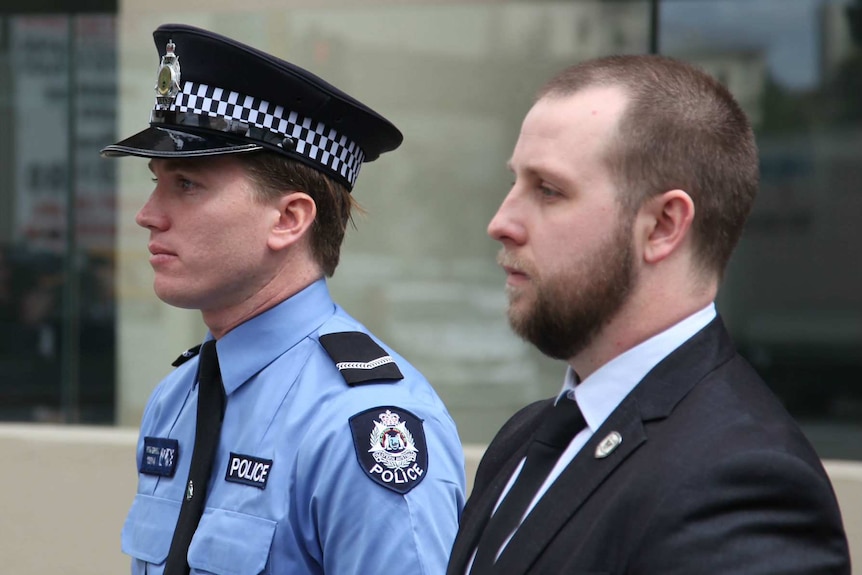 First Class constable Tom Gryta outside court with another, unknown man