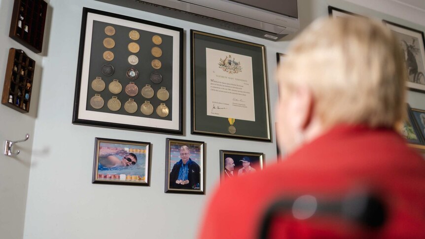 Elizabeth Edmondson gazes at her medals, certificates and photographs displayed on a wall at her Perth home.