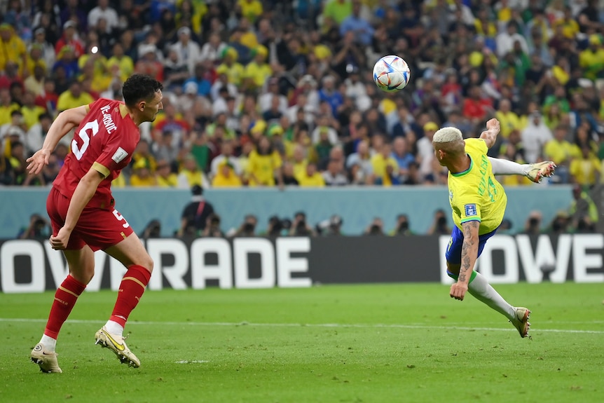Brazil's Richarlison prepares to kick a ball against Serbia.