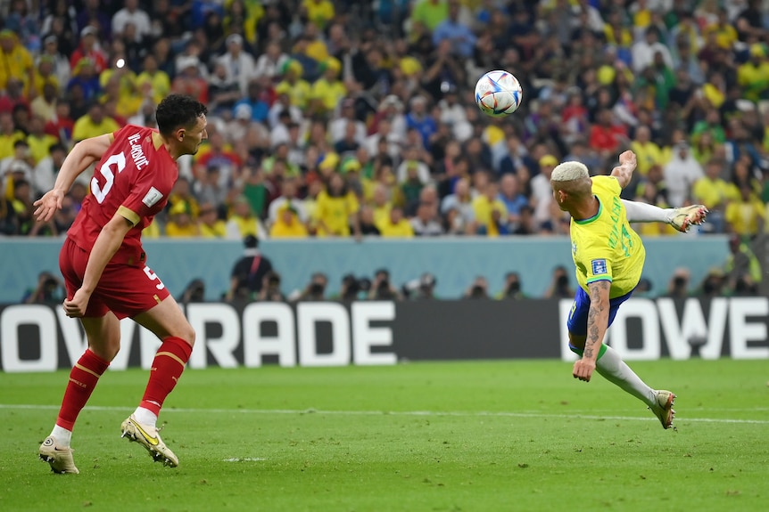 Richarlison of Brazil prepares to kick a ball against Serbia.