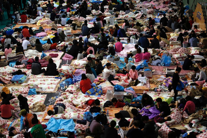 Family members of missing passengers on board South Korean ferry Sewol gather at a gym hall in Jindo