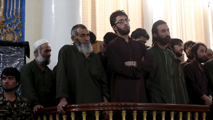 Defendants attend their trial at a court in Kabul