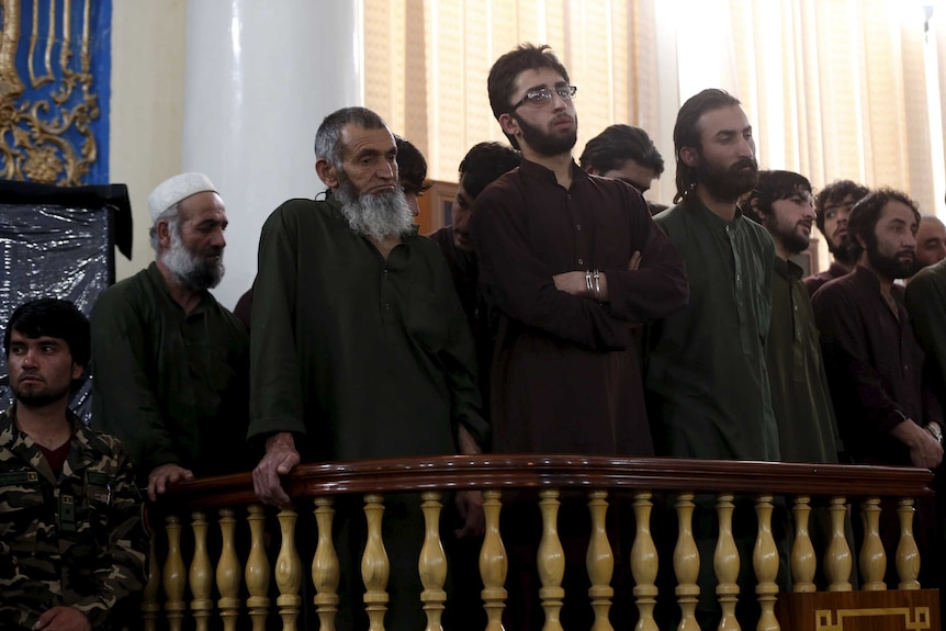 Defendants attend their trial at a court in Kabul