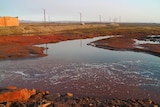 The oil spill outside Norilsk, the earth is red due to to the spill and the water also has a reddish tone.