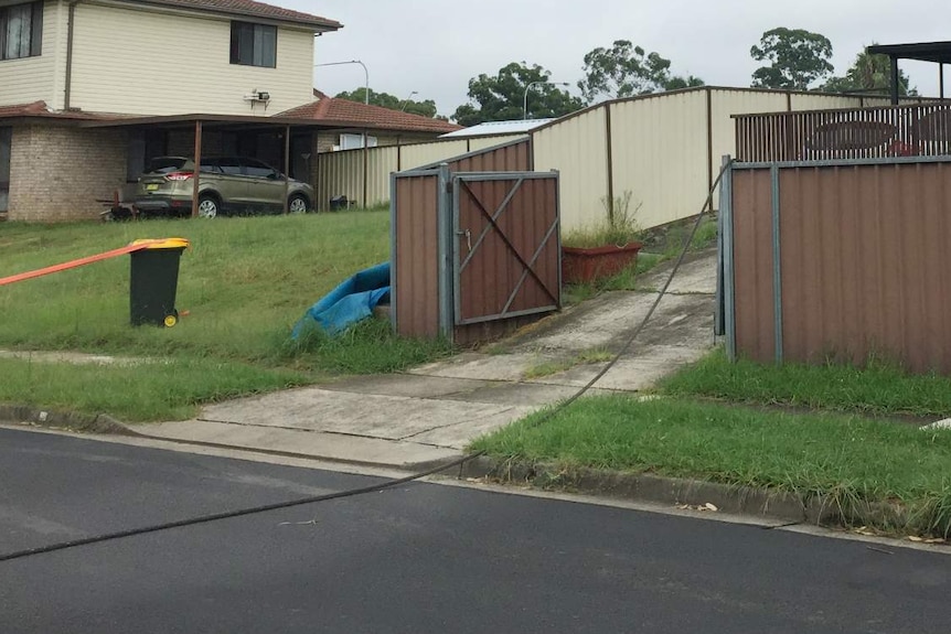 A power line hanging over a fence.