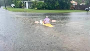 An elderly woman on a kayak.